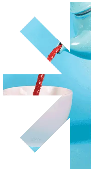 Half-ast-contact-1 – new classic – new classic Blue bottle pouring red liquid into a white cup, with the liquid streaming toward the cup.