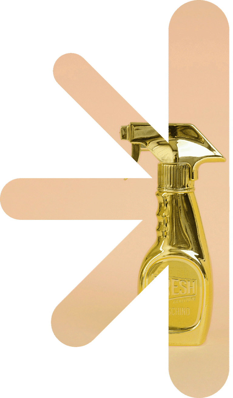 Half logo - spray bottle – new classic – new classic Gold perfume spray bottle with abstract peach shapes in the background, presenting a fashion-brand vibe.