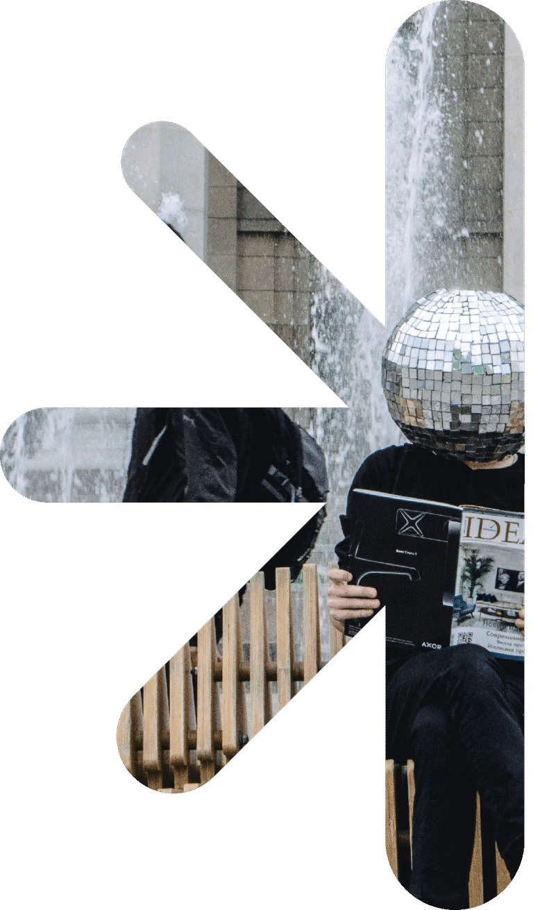 Half logo - ideas – new classic – new classic Abstract collage: a person in black with a mirrored disco-ball helmet sits by a fountain, holding a magazine; white geometric shapes overlay the scene.