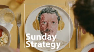 Hero banner showing a food-art portrait on a plate with yellow headphones, overlaid by the words 'Sunday Strategy' on a yellow table surface.